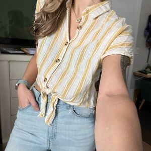 Women’s short sleeved cropped button up T-shirt. Size medium. Vertical stripes.